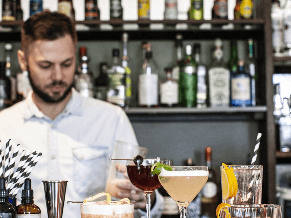 Waiter preparing cocktails at the bar