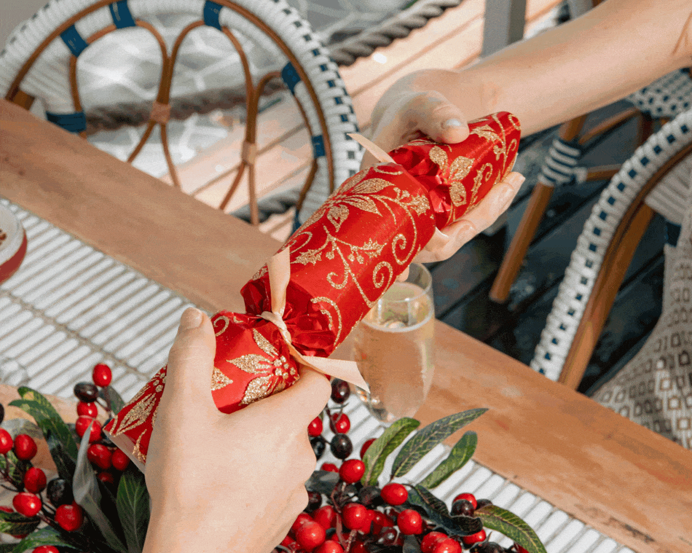 Pulling a Christmas bon bon over a Christmas table.